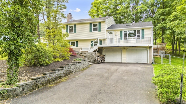 246 Rocky Top Rd, Hamden, CT 06514 - view of front of house with stairway, a chimney, a garage, and driveway
