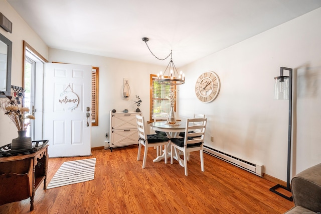 13 Hidden Knolls Cir Unit 13, Monroe, CT 06468 - dining area with a baseboard radiator, a chandelier, light wood-style floors, and baseboards