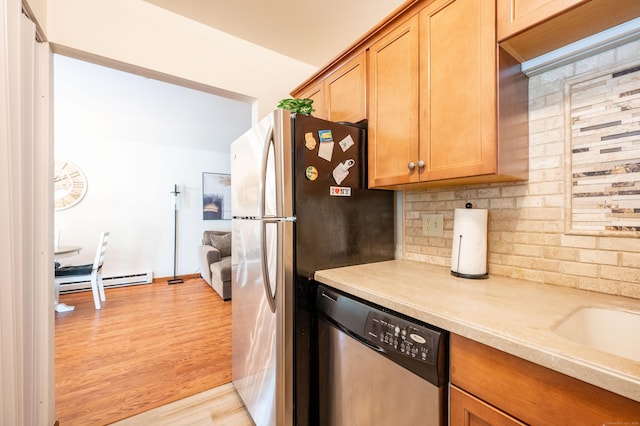 13 Hidden Knolls Cir Unit 13, Monroe, CT 06468 - kitchen featuring appliances with stainless steel finishes, decorative backsplash, light countertops, light wood-style flooring, and baseboard heating