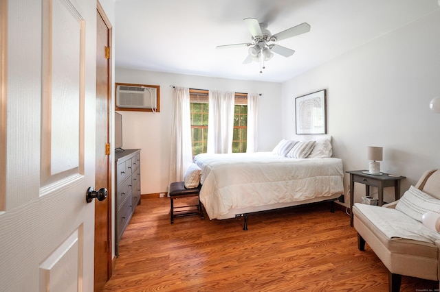 13 Hidden Knolls Cir Unit 13, Monroe, CT 06468 - bedroom with light wood finished floors, a wall mounted AC, baseboards, and ceiling fan