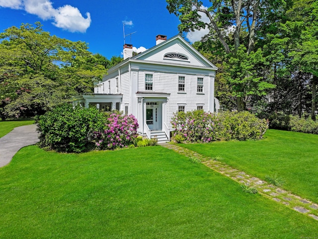 587 Carter St, New Canaan, CT 06840 - neoclassical home with a chimney and a front lawn