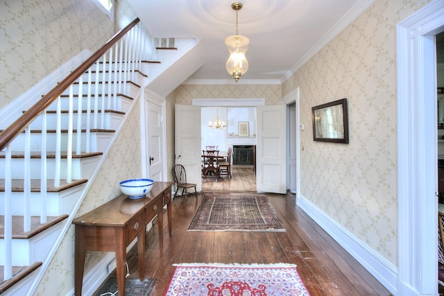 587 Carter St, New Canaan, CT 06840 - corridor featuring a chandelier, dark wood-style flooring, stairs, ornamental molding, and wallpapered walls