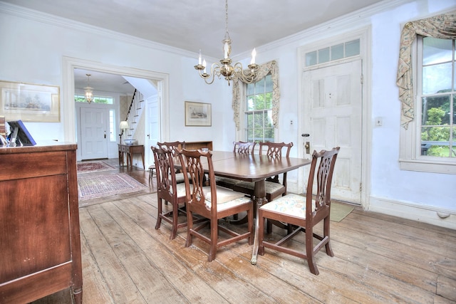 587 Carter St, New Canaan, CT 06840 - dining space with a chandelier, light wood-style floors, and crown molding