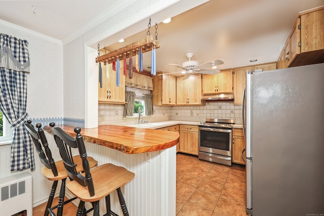 70 Cold Spring Cir, Naugatuck, CT 06770 - kitchen with appliances with stainless steel finishes, a peninsula, a sink, crown molding, and decorative backsplash