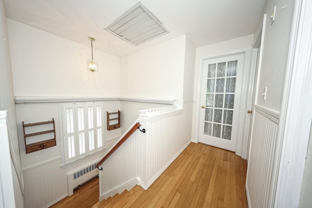 70 Cold Spring Cir, Naugatuck, CT 06770 - hall with an upstairs landing, radiator, wainscoting, and light wood-type flooring