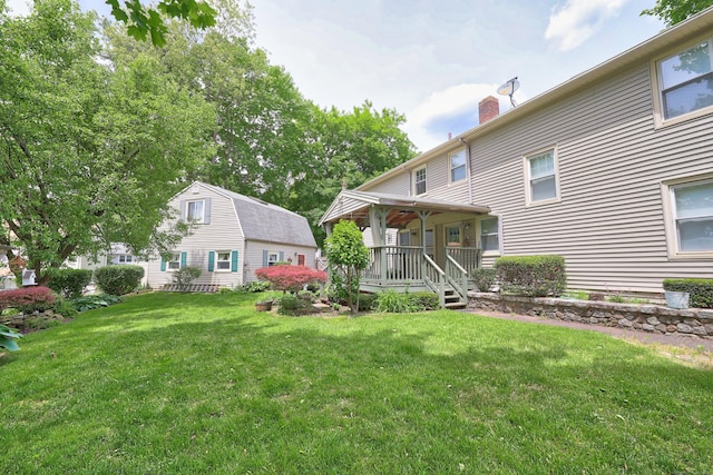 70 Cold Spring Cir, Naugatuck, CT 06770 - rear view of property featuring a chimney, a yard, and a porch