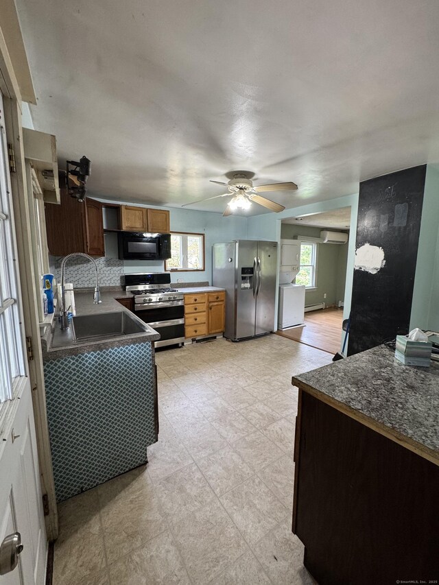 160 New Litchfield St, Torrington, CT 06790 - kitchen featuring appliances with stainless steel finishes, a sink, dark countertops, ceiling fan, and brown cabinetry