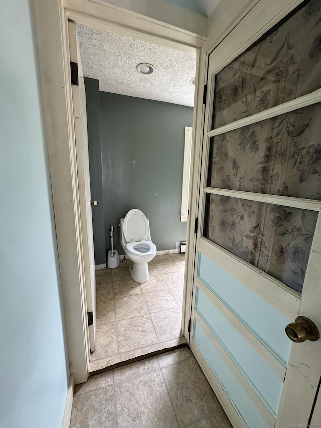 160 New Litchfield St, Torrington, CT 06790 - bathroom featuring toilet, baseboards, and a textured ceiling