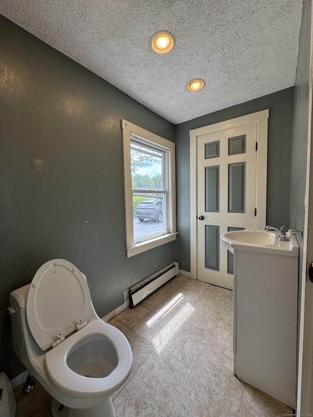 160 New Litchfield St, Torrington, CT 06790 - half bathroom with baseboard heating, vanity, toilet, and a textured ceiling