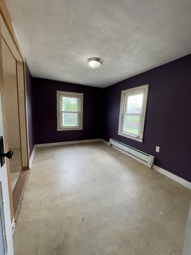 160 New Litchfield St, Torrington, CT 06790 - empty room with a baseboard heating unit, a textured ceiling, and baseboards
