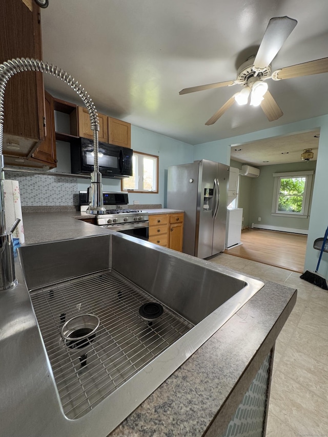 160 New Litchfield St, Torrington, CT 06790 - kitchen featuring stainless steel appliances, open shelves, plenty of natural light, and a ceiling fan