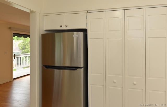 8 Heritage Vlg Unit D, Southbury, CT 06488 - kitchen featuring freestanding refrigerator, white cabinetry, and wood finished floors