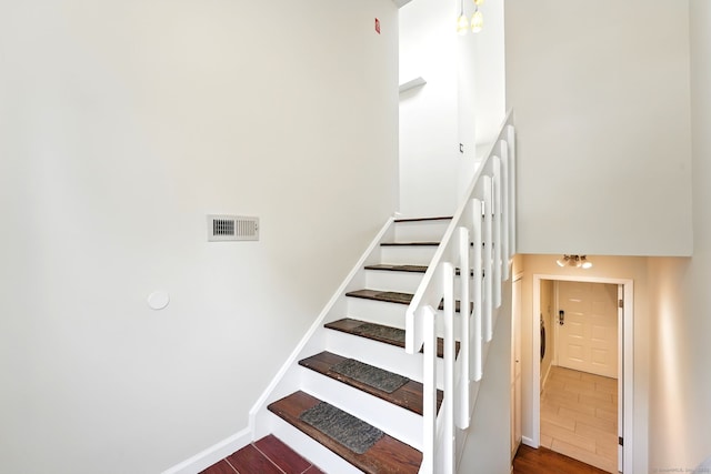 27 Pheasant Run Unit 27, Cromwell, CT 06416 - stairway with wood finished floors, a towering ceiling, and baseboards