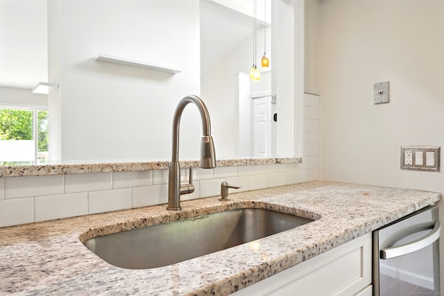 27 Pheasant Run Unit 27, Cromwell, CT 06416 - detailed view of a sink, light stone counters, white cabinetry, and dishwasher