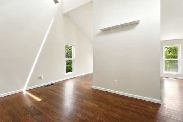 27 Pheasant Run Unit 27, Cromwell, CT 06416 - unfurnished living room with dark wood-type flooring, a towering ceiling, and baseboards