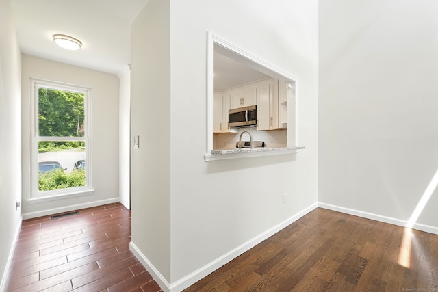 27 Pheasant Run Unit 27, Cromwell, CT 06416 - hallway featuring dark wood-style flooring and baseboards