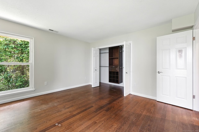 27 Pheasant Run Unit 27, Cromwell, CT 06416 - unfurnished bedroom featuring dark wood finished floors, baseboards, and a closet