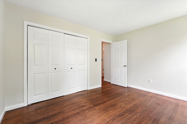 27 Pheasant Run Unit 27, Cromwell, CT 06416 - unfurnished bedroom featuring dark wood finished floors, baseboards, and a closet