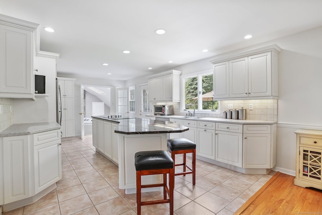 7 Silva Ter, Oxford, CT 06478 - kitchen with a sink, backsplash, recessed lighting, white cabinets, and a kitchen breakfast bar