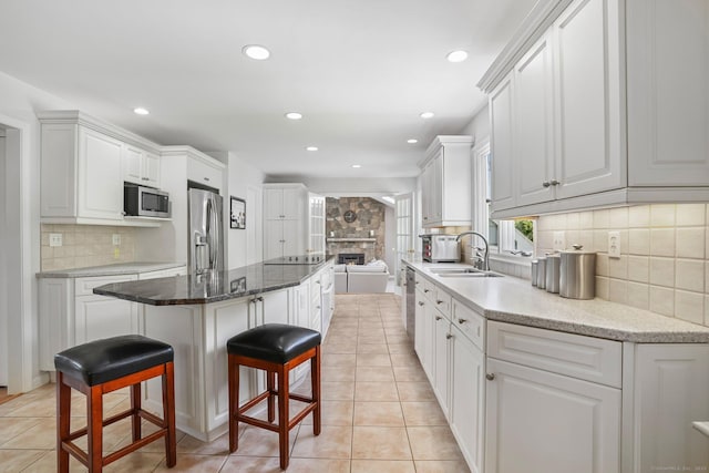 7 Silva Ter, Oxford, CT 06478 - kitchen featuring appliances with stainless steel finishes, a sink, a center island, light tile patterned flooring, and recessed lighting