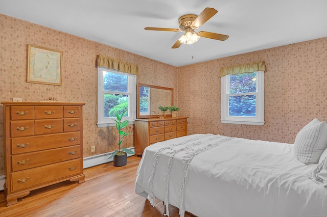 30 Fairlawn Rd, Glastonbury, CT 06033 - bedroom with multiple windows, light wood-type flooring, a baseboard radiator, wallpapered walls, and a ceiling fan