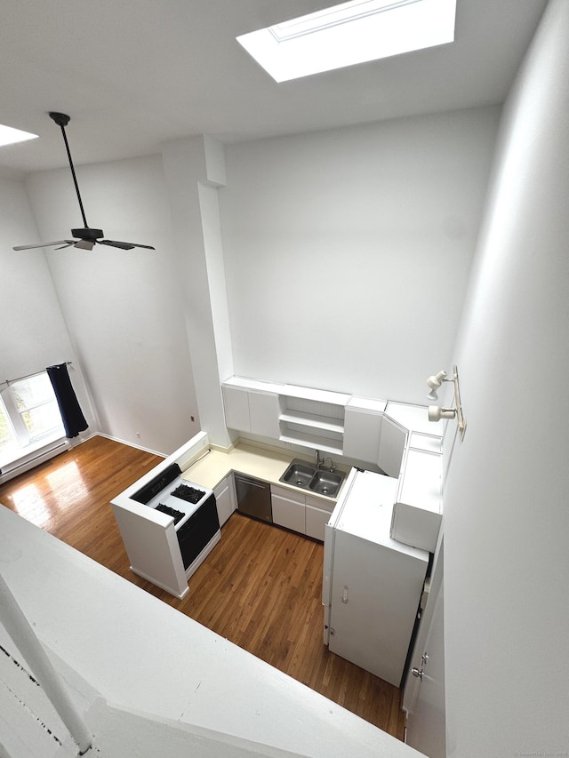 32 Pine St Unit 12Aka 15, Norwalk, CT 06854 - kitchen featuring a skylight, dark wood finished floors, a sink, light countertops, and a peninsula