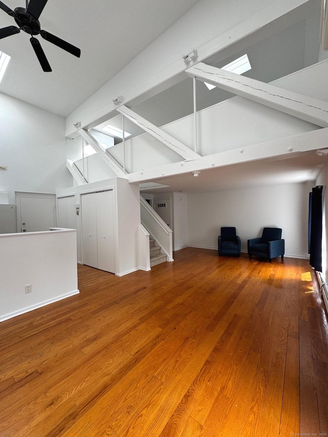 32 Pine St Unit 12Aka 15, Norwalk, CT 06854 - unfurnished living room with a skylight, a ceiling fan, wood finished floors, and baseboards