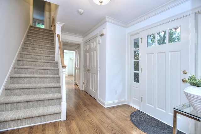 52 Woodside Ave, Westport, CT 06880 - entrance foyer with stairs, wood finished floors, and crown molding