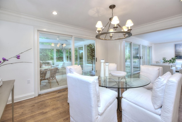 52 Woodside Ave, Westport, CT 06880 - dining room with a chandelier, crown molding, wood finished floors, and recessed lighting