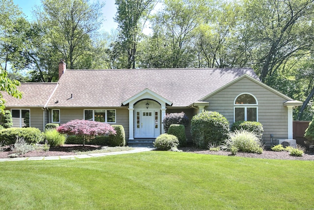 52 Woodside Ave, Westport, CT 06880 - ranch-style house with a front yard, a chimney, and roof with shingles
