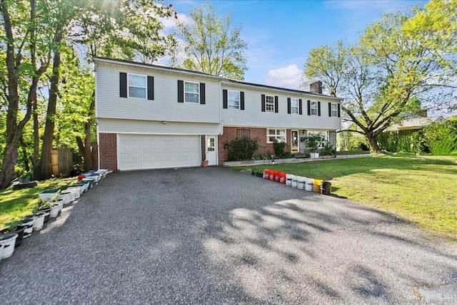 146 Whitewood Rd, Torrington, CT 06790 - colonial home featuring brick siding, a garage, a chimney, a front yard, and asphalt driveway