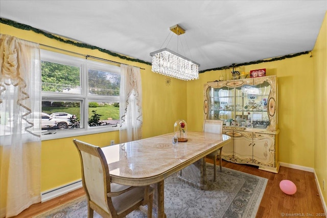 146 Whitewood Rd, Torrington, CT 06790 - dining room with a baseboard radiator, a chandelier, wood finished floors, and baseboards