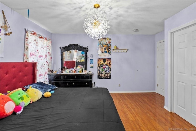 146 Whitewood Rd, Torrington, CT 06790 - bedroom featuring wood finished floors, a chandelier, and baseboards