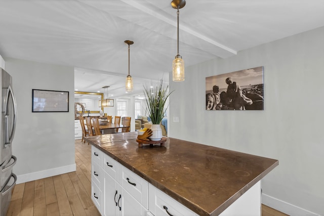 11 Pearl St, Groton, CT 06340 - kitchen with dark countertops, light wood finished floors, baseboards, and white cabinets