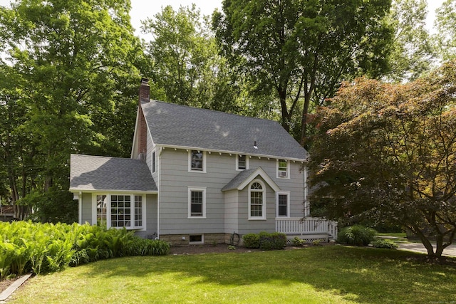 102 Rose Ln, Darien, CT 06820 - rear view of property featuring a shingled roof, a chimney, and a yard