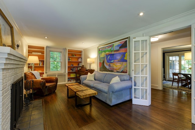 102 Rose Ln, Darien, CT 06820 - living area with dark wood-style flooring, built in shelves, ornamental molding, healthy amount of natural light, and a brick fireplace
