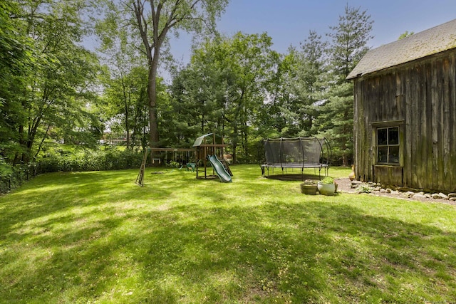 102 Rose Ln, Darien, CT 06820 - view of green lawn with a trampoline, a playground, and view of wooded area