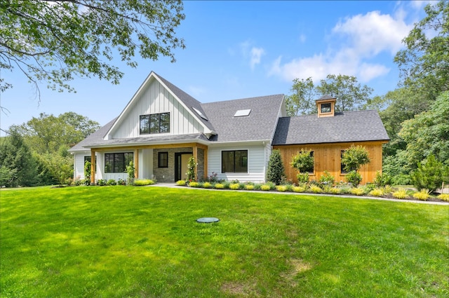 10 Singing Woods Rd, Norwalk, CT 06850 - view of front facade with board and batten siding, a front lawn, and roof with shingles