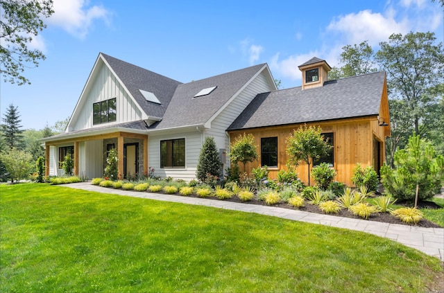 10 Singing Woods Rd, Norwalk, CT 06850 - view of front of house featuring a front lawn, roof with shingles, and board and batten siding