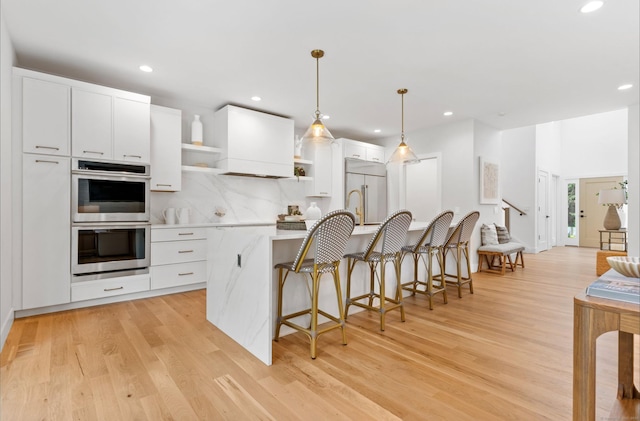 10 Singing Woods Rd, Norwalk, CT 06850 - kitchen with stainless steel double oven, built in fridge, open shelves, light wood-type flooring, and recessed lighting