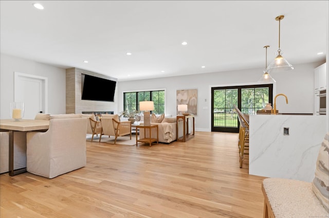 10 Singing Woods Rd, Norwalk, CT 06850 - living room with light wood-type flooring, recessed lighting, and a large fireplace
