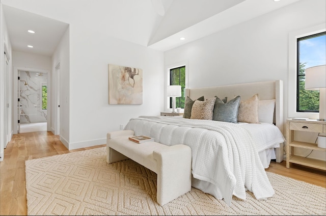 10 Singing Woods Rd, Norwalk, CT 06850 - bedroom featuring multiple windows, light wood-style flooring, recessed lighting, and lofted ceiling