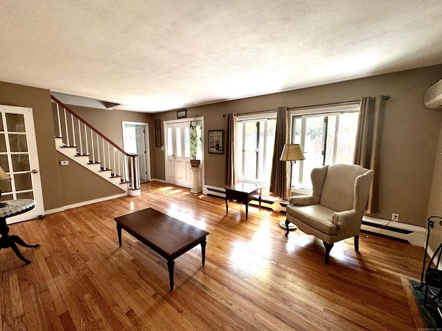 10 Laurel Trl, Durham, CT 06422 - living area featuring wood finished floors, a textured ceiling, stairs, baseboard heating, and baseboards