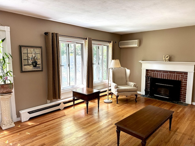 10 Laurel Trl, Durham, CT 06422 - living area featuring a wall mounted air conditioner, wood finished floors, a fireplace, and baseboard heating