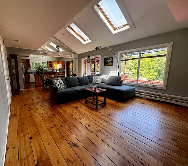 10 Laurel Trl, Durham, CT 06422 - living area with a skylight, a baseboard heating unit, vaulted ceiling, and wood-type flooring