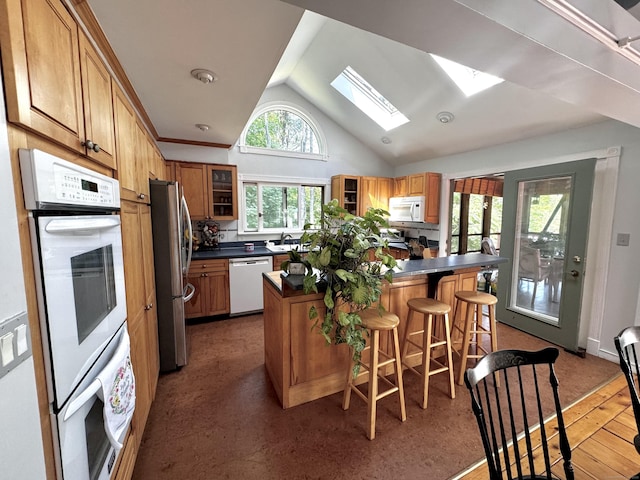 10 Laurel Trl, Durham, CT 06422 - kitchen with white appliances, dark countertops, a kitchen island, glass insert cabinets, and lofted ceiling