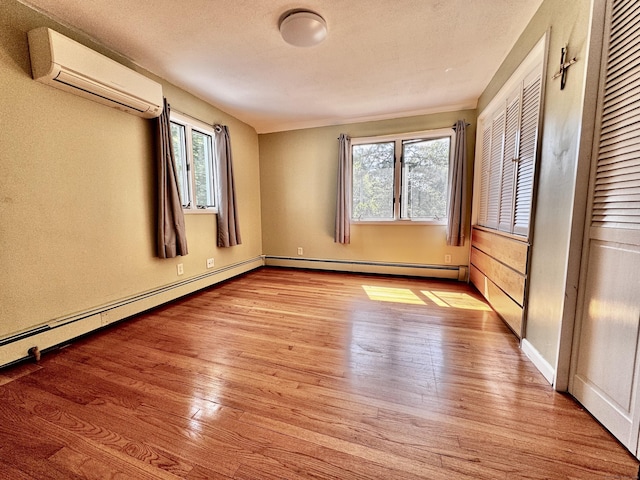 10 Laurel Trl, Durham, CT 06422 - spare room with a wall mounted air conditioner, wood-type flooring, healthy amount of natural light, and baseboards