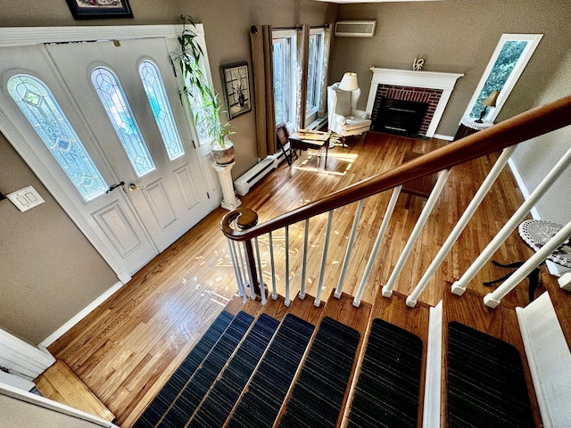 10 Laurel Trl, Durham, CT 06422 - entrance foyer with a wall mounted air conditioner, wood finished floors, stairs, and a baseboard radiator
