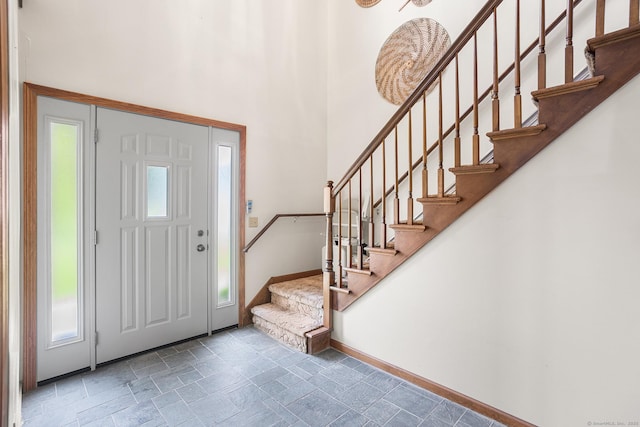 1441 Woodtick Rd, Wolcott, CT 06716 - entrance foyer featuring baseboards, stairs, a high ceiling, and stone finish flooring