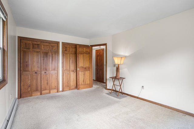 1441 Woodtick Rd, Wolcott, CT 06716 - unfurnished bedroom featuring a baseboard heating unit, carpet, two closets, and baseboards